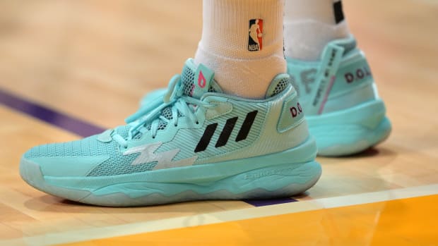 View of blue Adidas Dame shoes.